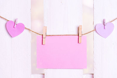 Close-up of papers hanging against wall