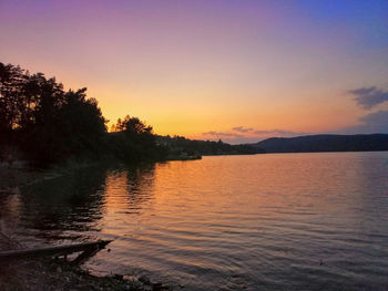 Scenic view of lake against sky during sunset