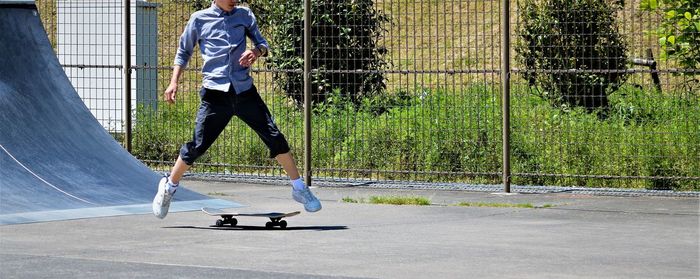 Low section of boy skateboarding