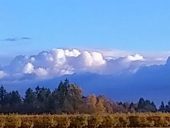 Scenic view of land and mountains against sky