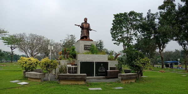 Statue against trees and sky