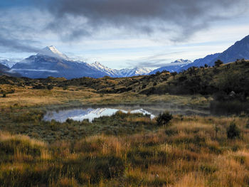 Scenic view of lake and mountains against sky