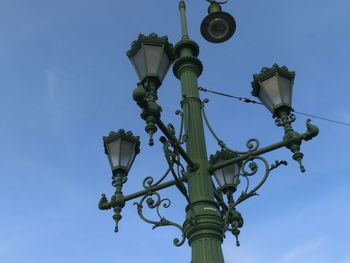 Low angle view of street light against blue sky