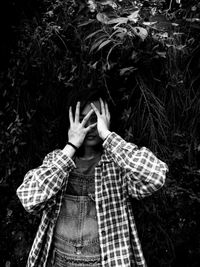 High angle view of person standing by plants against black background