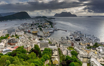 High angle view of townscape by sea against sky