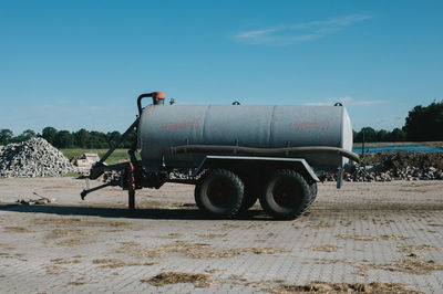 Fuel tanker at construction site against sky