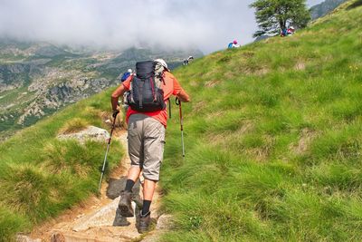 Rear view of man hiking on mountain