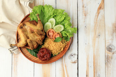 Ayam goreng kremes. popular fried chicken dish from jogjakarta, deep fried whole chicken 