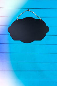 Close-up of silhouette person against blue wall