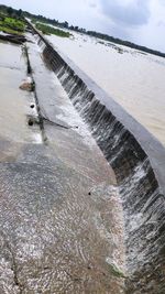 High angle view of water flowing in dam