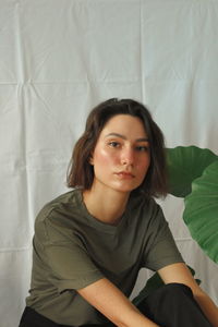 Portrait of young woman sitting at home