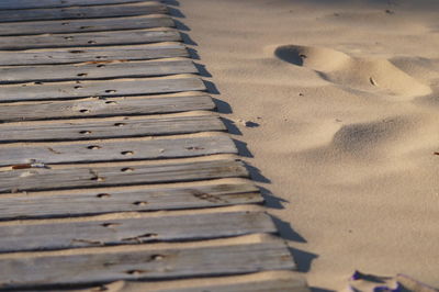 Close-up of wood on sand at beach