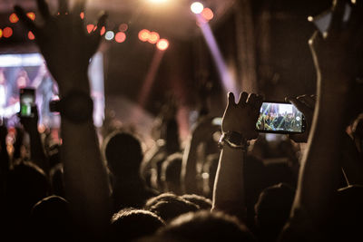 People photographing at music concert