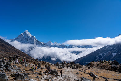 Scenic view of snowcapped mountains against blue sky