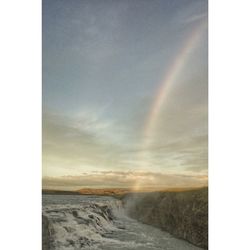 Scenic view of rainbow over trees