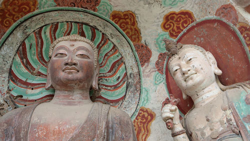 Low angle view of statue of statues against building