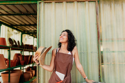 Close-up smiling woman standing outdoors