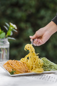 Cropped hand of woman holding food