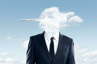 Digital composite image of businessman with clouds