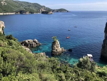 High angle view of rocks by sea against sky