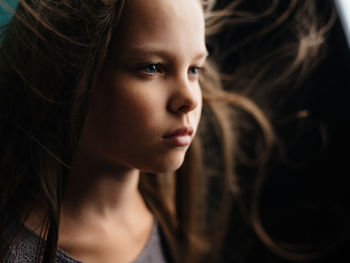 Close-up portrait of young woman looking away