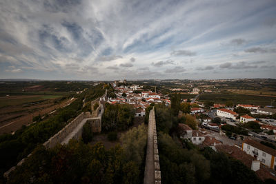 High angle view of town against cloudy sky