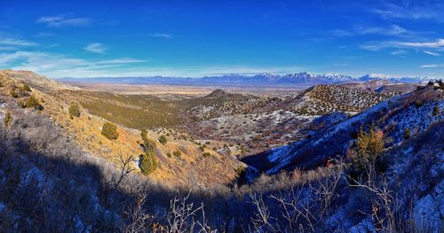 Panoramic view of landscape against blue sky