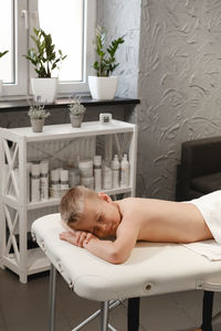 Child after back massage treatment in therapy clinic relaxing. kid body treatment