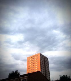 Low angle view of building against cloudy sky