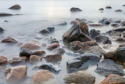 Panoramic shot of pebbles on beach against sky