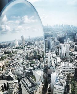 High angle view of modern buildings in city against sky