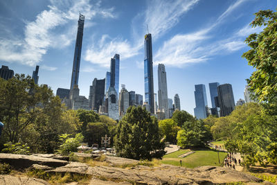 Panoramic view of trees and buildings against sky