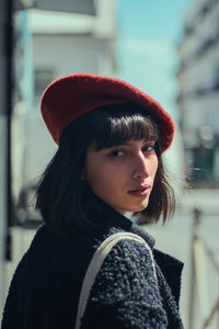 Portrait of young woman in city