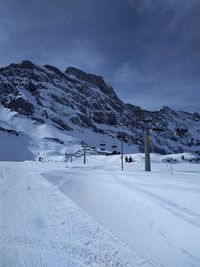 Scenic view of snow covered mountains against sky