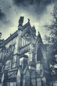 Low angle view of building against cloudy sky