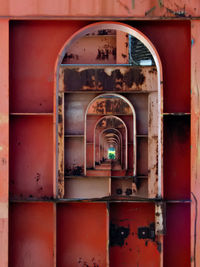 Full frame shot of red metallic door with window