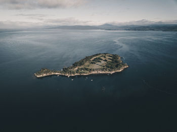 High angle view of island in sea against sky