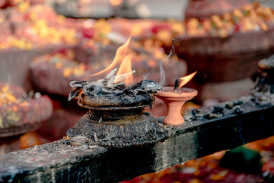 Lit oil and butter candles scatter their sacred and fragrant smoke 
