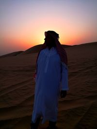 Full length of arab man standing in desert