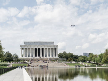 People at lincoln memorial against cloudy sky