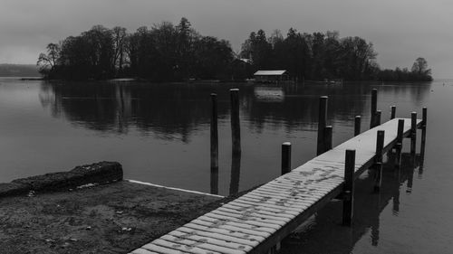 Pier on lake against sky