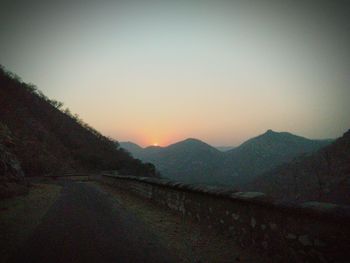 Scenic view of mountains against clear sky during sunset