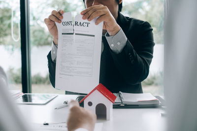 Low section of person working on paper