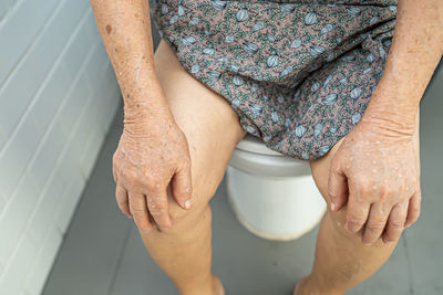 Midsection of woman standing in bathroom