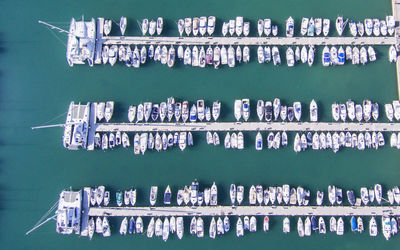 Aerial view of boats moored on sea at harbor