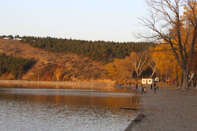 People at beach against mountain