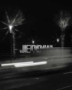 Illuminated road sign at night