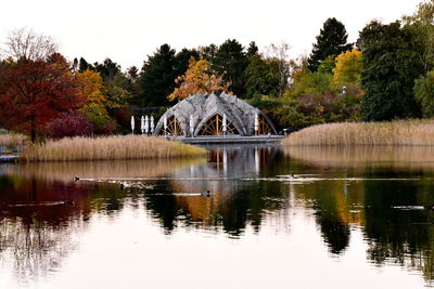 Arch bridge over lake against sky