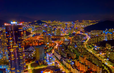 High angle view of illuminated city buildings at night