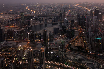 High angle view of city lit up at night